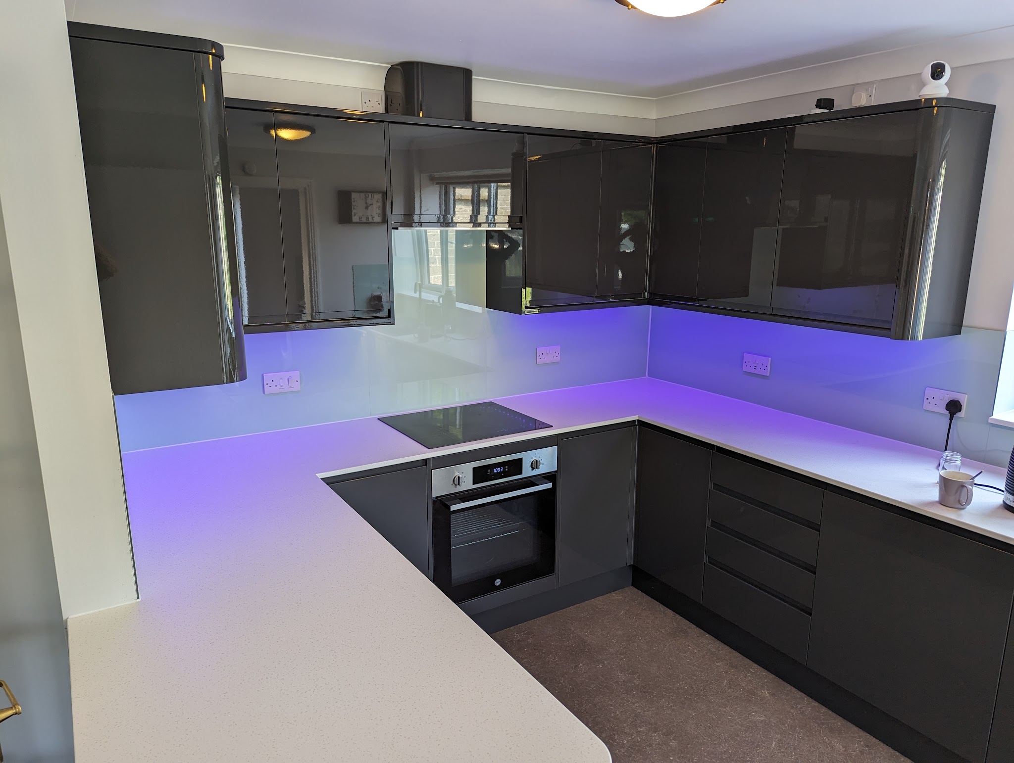Dark gloss kitchen with white worktops
