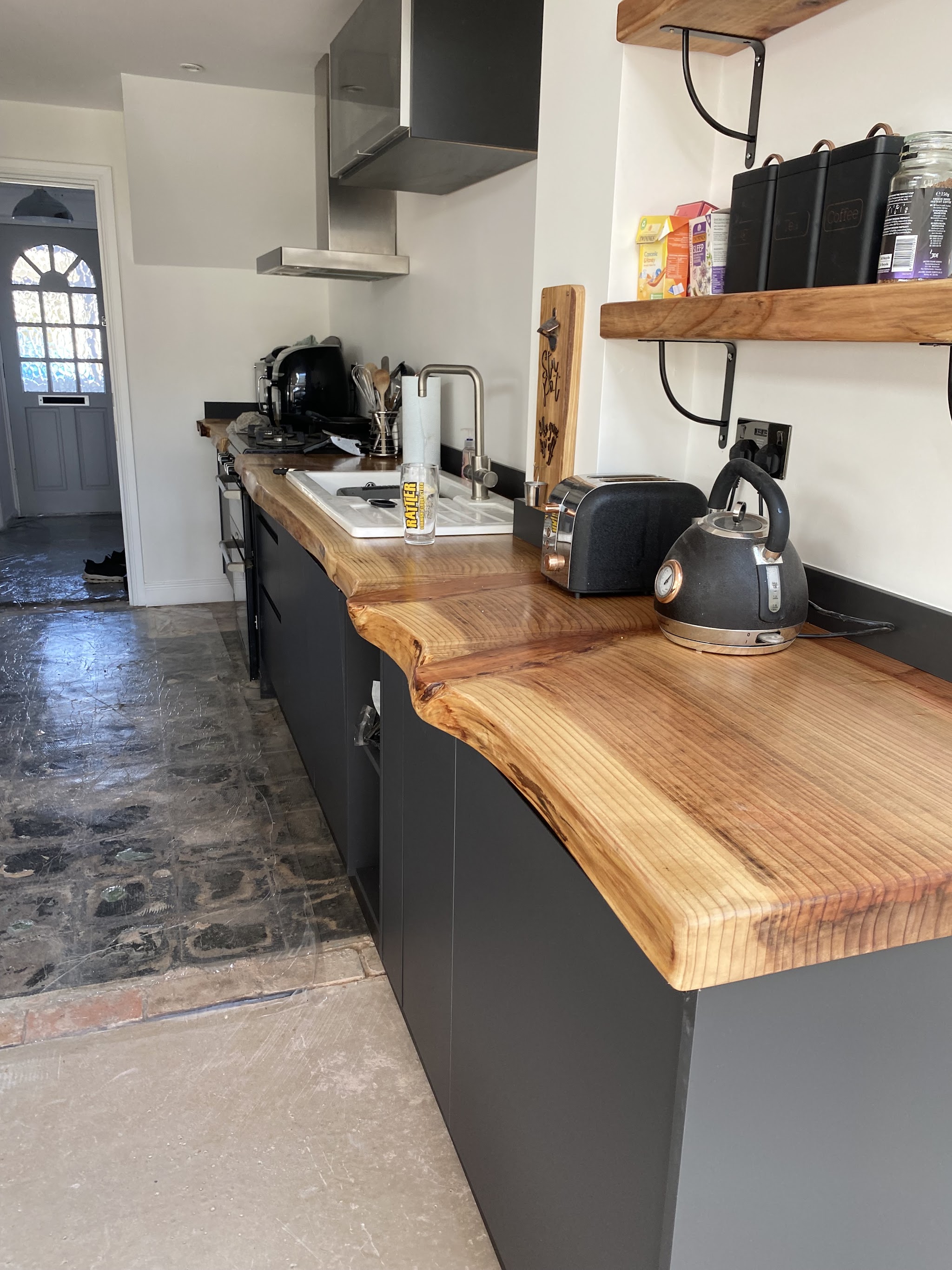 Galley kitchen with a live-edge oak worktop and open shelving