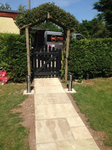 Stone path through a hedge archway