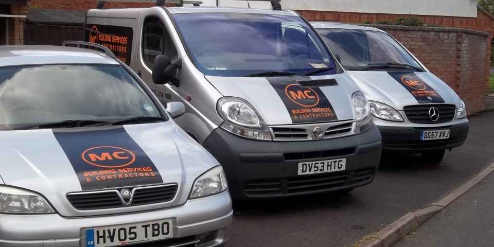 M C Building Services vans outside a job