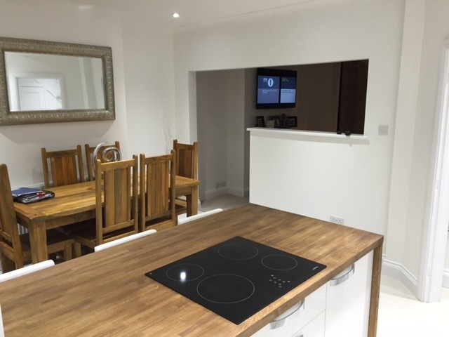 Oak worktop with an induction hob and a dining area beyond