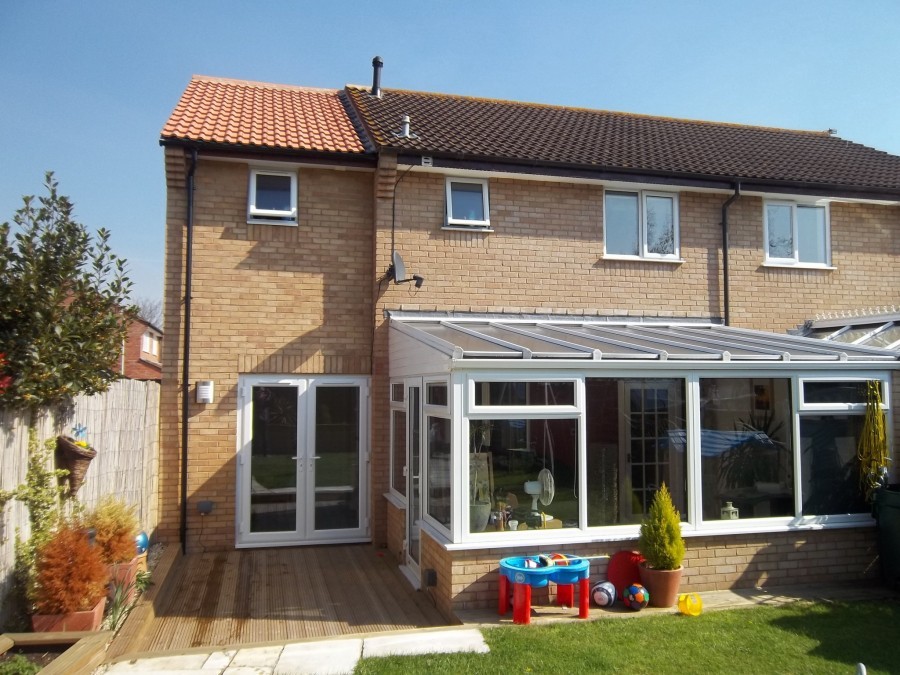Rear view with conservatory and new extension