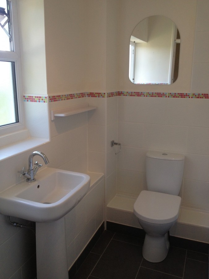 White bathroom with a decorative tile border