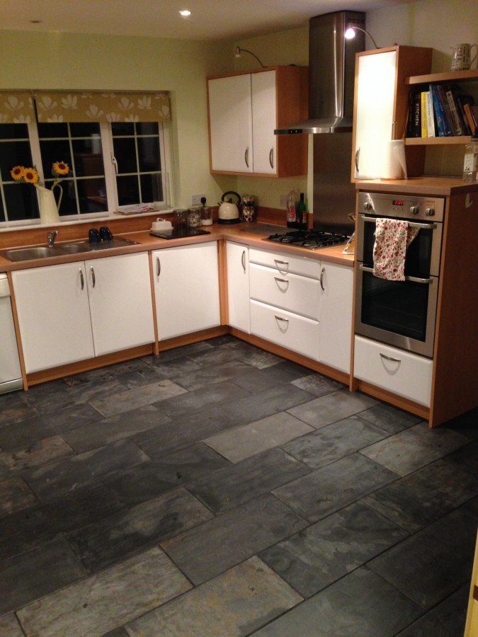 Kitchen with slate floor and timber-trimmed units