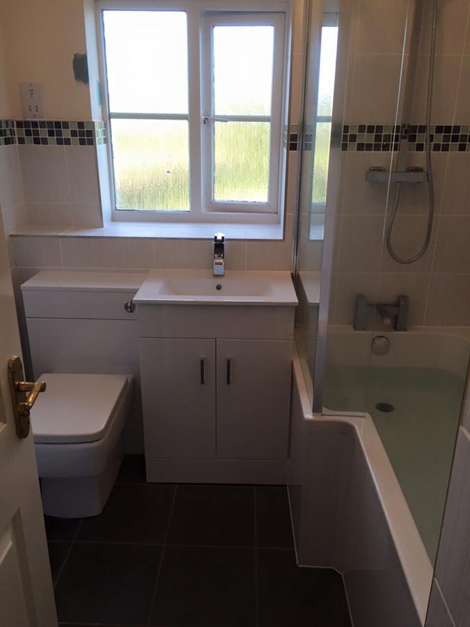 Bathroom with a vanity unit and mosaic border