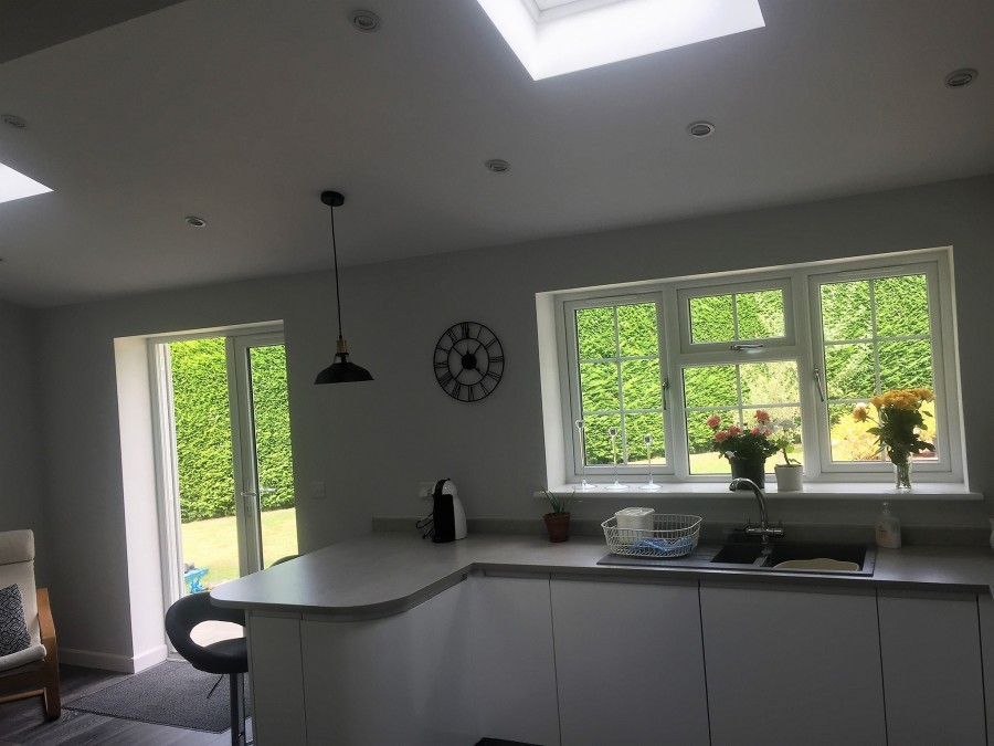 Extension kitchen with a curved worktop and garden doors