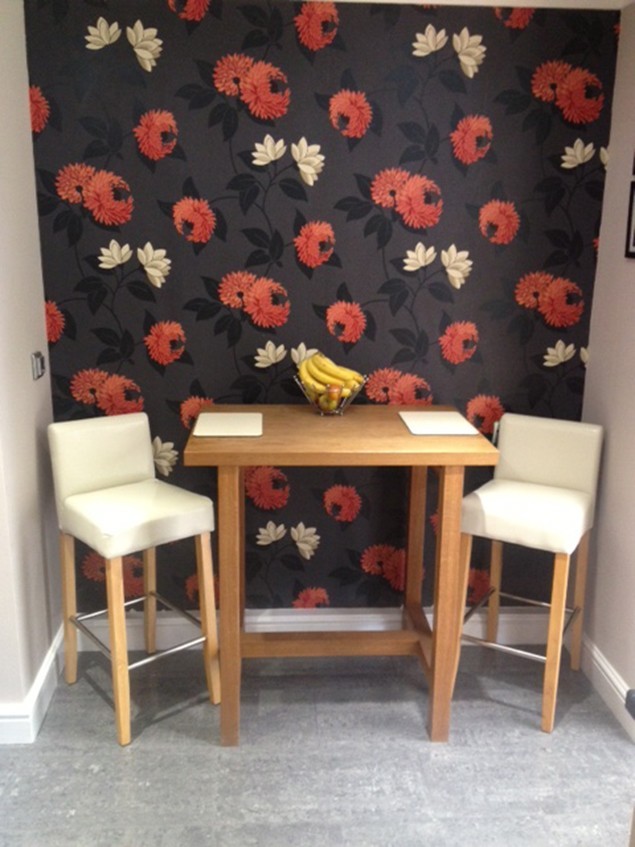 Breakfast bar with stools against a feature wallpaper